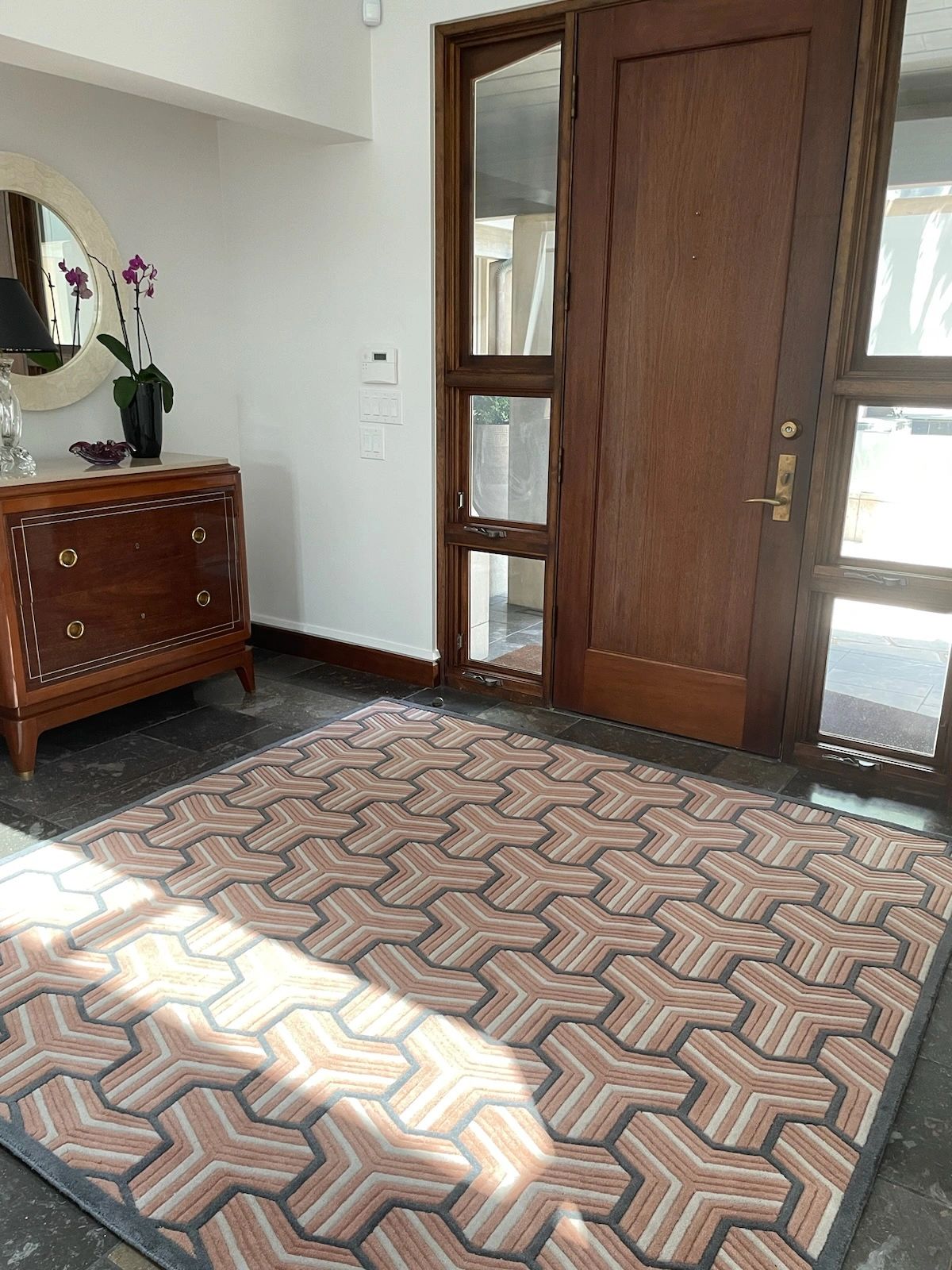 Custom geometric rug in an Austin entryway, supplied by Benson Carpet and Floors